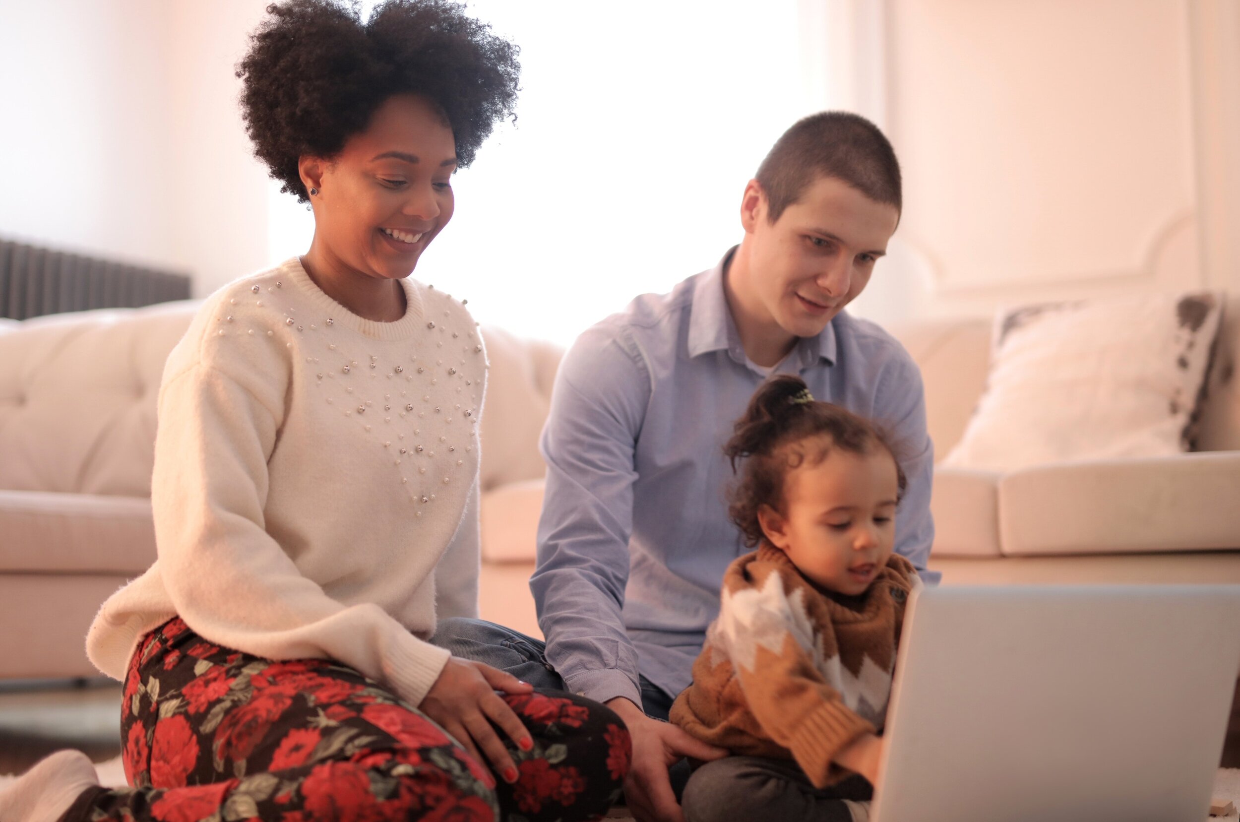photo-of-family-sitting-on-floor-while-using-laptop-3820173.jpg